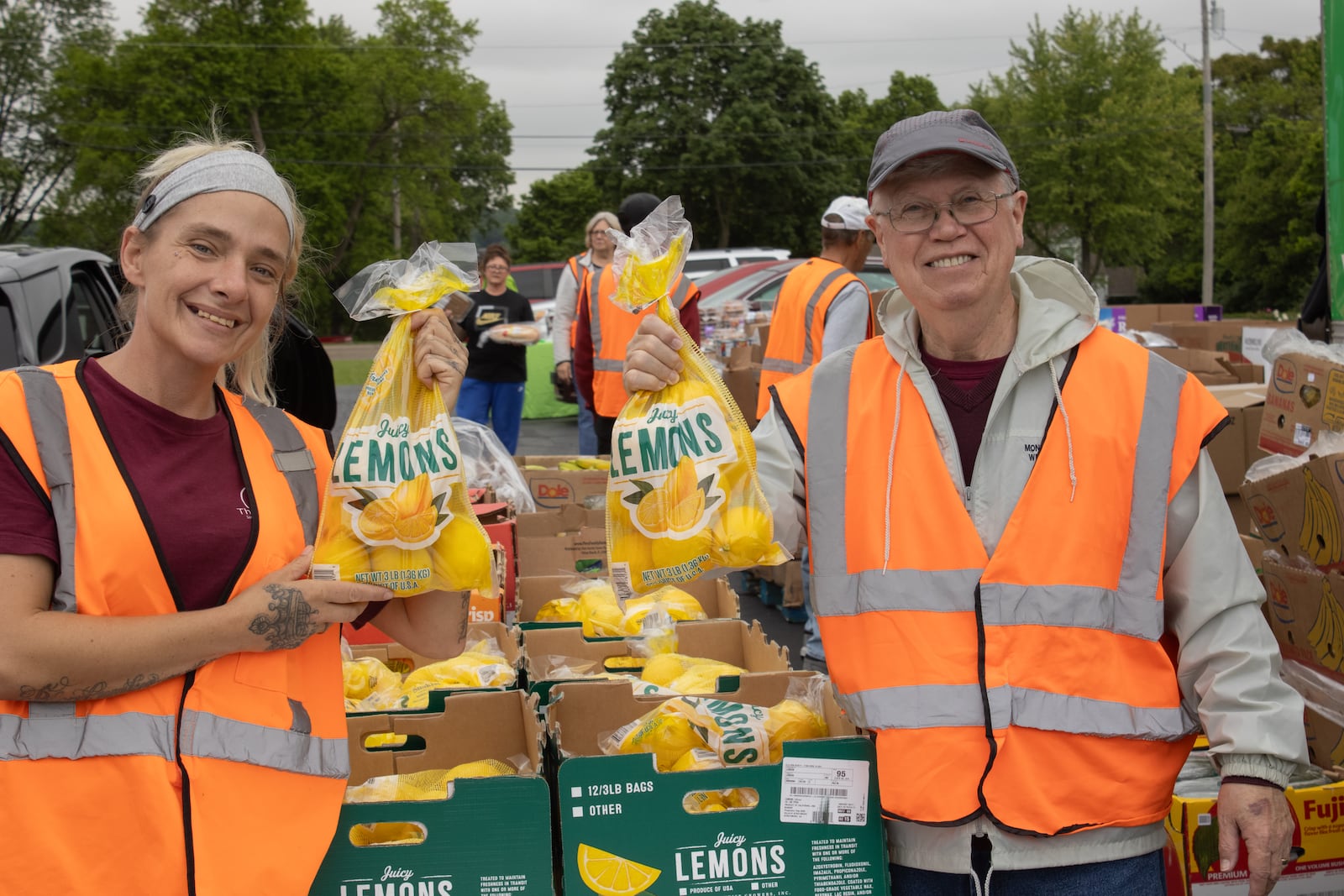 Foodbank employee Carolyn Rife (left) and a volunteer holding lemons at a mobile pantry. CONTRIBUTED