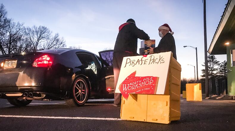 Pirate Packs volunteers deliver pick-up food and gifts for children behind the Payne Recreation Center in Moraine.