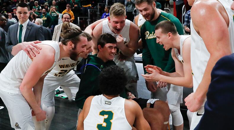 Wright State playerscelebrate their 74-57 win against Cleveland State with Ryan Custer after an NCAA basketball game in the Horizon League tournament championship in Detroit, Tuesday, March 6, 2018. (AP Photo/Paul Sancya)