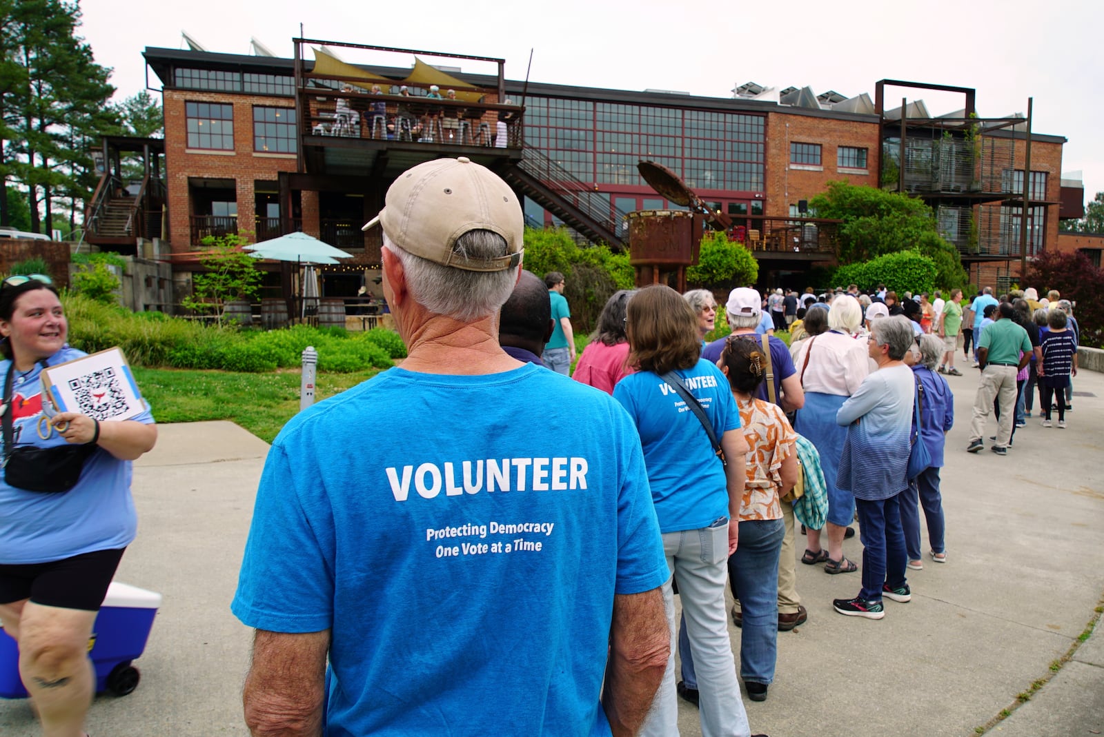People line up outside the Haw River Ball Room to attend a town hall with Sen. Chris Murphy, D-Conn., and Rep. Maxwell Frost, D-Fla., in Saxapahaw, N.C., Thursday, April 24, 2025. (AP Photo/Allen G. Breed)
