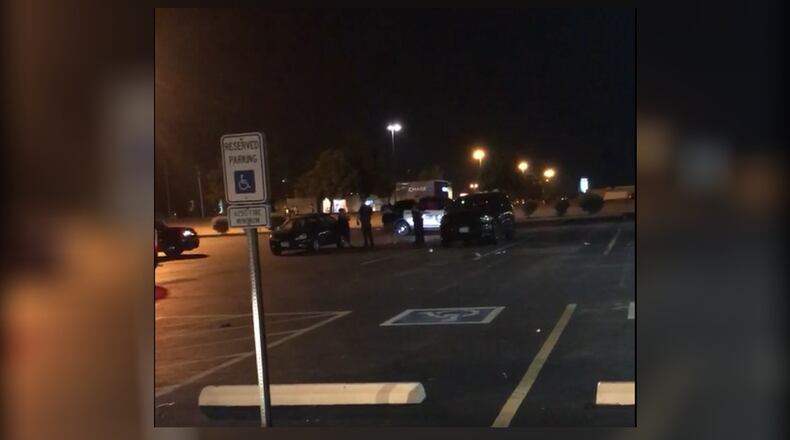 Huber Heights police survey the area parking lot of Get Air trampoline facility on Chambersburg Road after multiple car break-ins were reported on Saturday, June 9.