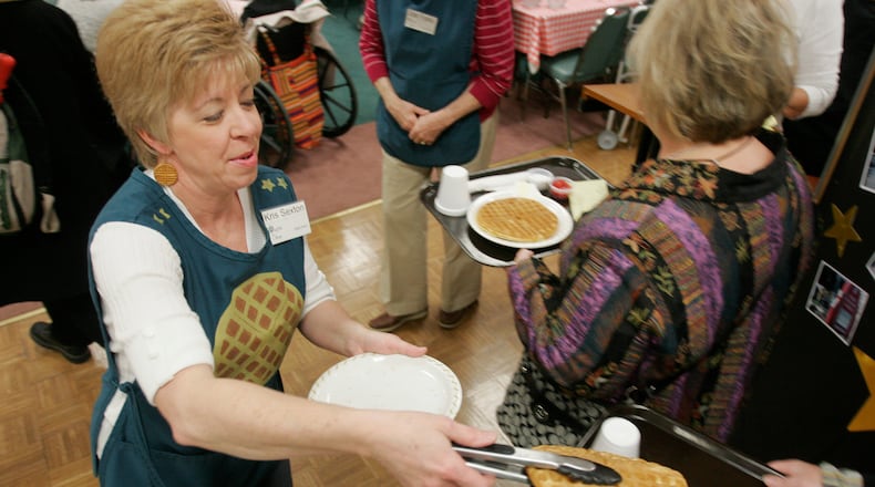 Kris Sexton serves up waffles at the 82nd annual Waffle Shop fundraiser held at Christ Episcopal Church. The Waffle Shop raising money for programs that serve downtown Dayton. The event goes from Nov. 15 thru 18 and from 11am to 2pm. STAFF PHOTO JIM NOELKER