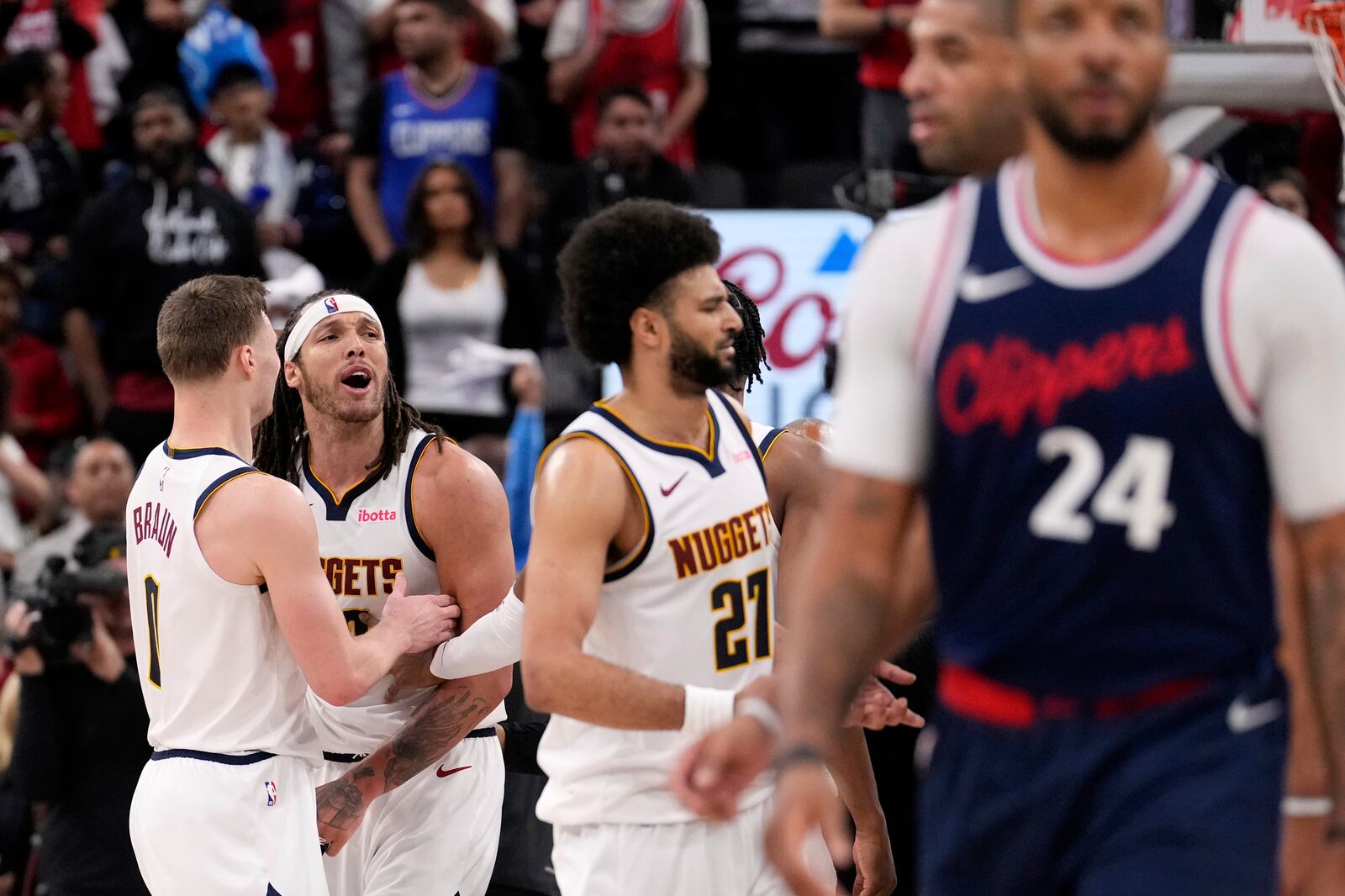 Denver Nuggets forward Aaron Gordon, second from left, yells to members of the Los Angeles Clippers after he was involved in a scuffle during the first half in Game 4 of an NBA basketball first-round playoff series Saturday, April 26, 2025, in Inglewood, Calif. (AP Photo/Mark J. Terrill)