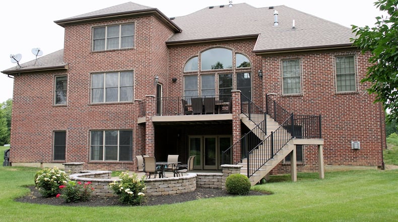 The balcony deck is accessible from the breakfast room and the first-floor main bedroom. The finished lower level walks out to a paver-brick patio and a fountain. There is a bonus room above the 3-car garage.