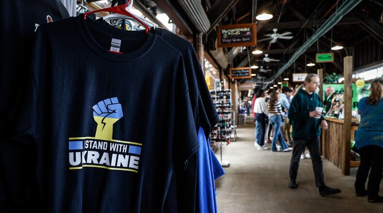 Ukraine tee shirts are being sold at the 2nd Street Market in Dayton. The market crowds are getting larger after two years of COVID restrictions. JIM NOELKER/STAFF