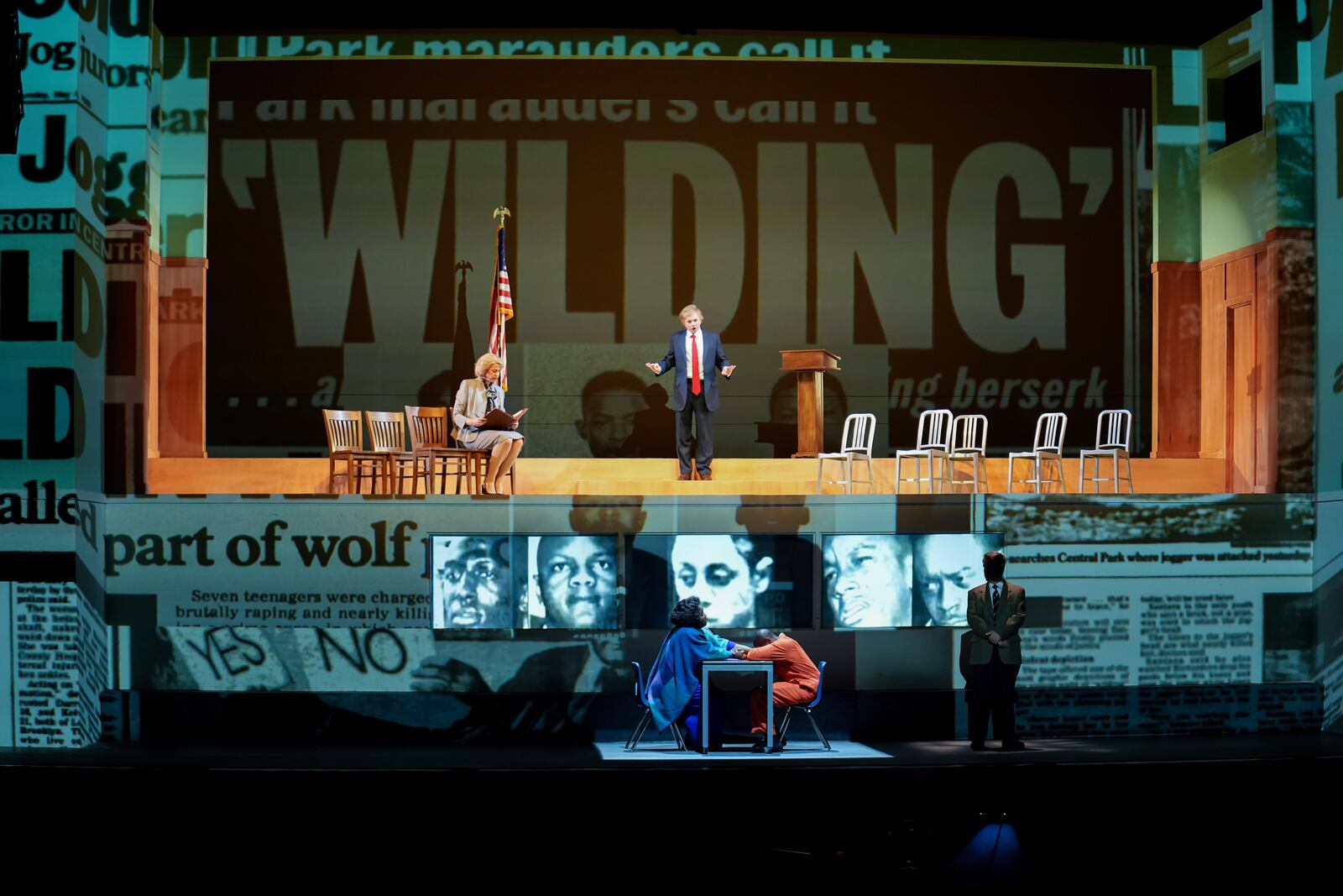 In this photo provided by the Detroit Opera is a scene from Detroit Opera's performance of Anthony Davis's "The Central Park Five," with Catherine Martin, left, on stage, and Todd Strange, and lower level Brianna J. Robinson, Justin Hopkins, and Daniel Belcher. (Austin T. Richey/Detroit Opera via AP)