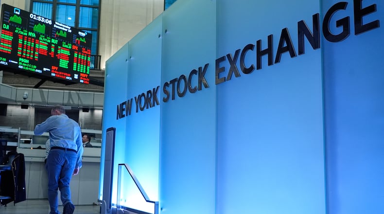 Traders work on the floor at the New York Stock Exchange in New York, Wednesday, Dec. 10, 2025. (AP Photo/Seth Wenig)
