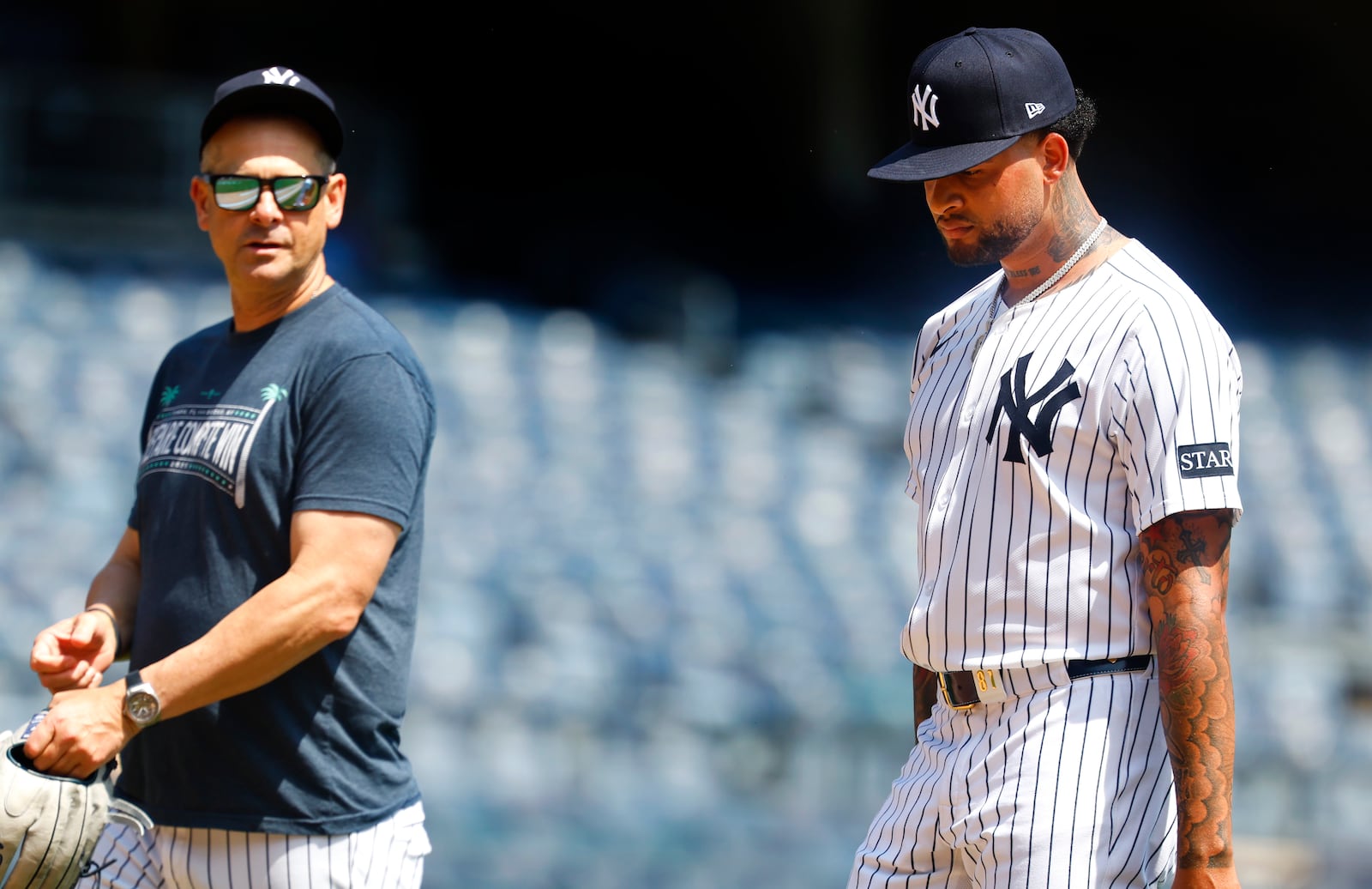 New York Yankees' manager Aaron Boone and Luis Gil talk during live batting practice before a baseball game against the Baltimore Orioles, Saturday, June 21, 2025, in New York. (AP Photo/Noah K. Murray)