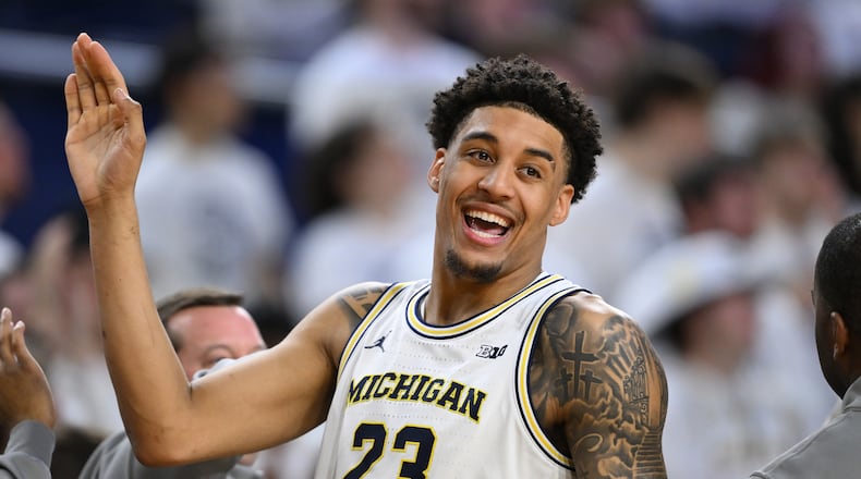 Michigan forward Yaxel Lendeborg (23) smiles as he celebrates with his teammates in the waning seconds of their win over UCLA in an NCAA college basketball game in Ann Arbor, Mich., Saturday, Feb. 14, 2026. (AP Photo/Lon Horwedel)