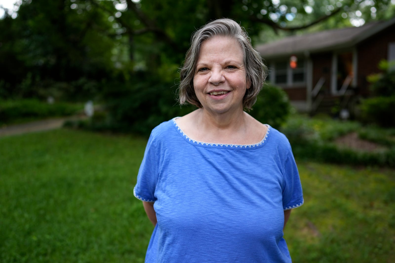Carol Seegar, who has a deep brain stimulator, powered by an Abbott Brio IPG, implanted in her body, poses for a photo on Thursday, July 24, 2025, in Atlanta. (AP Photo/Mike Stewart)