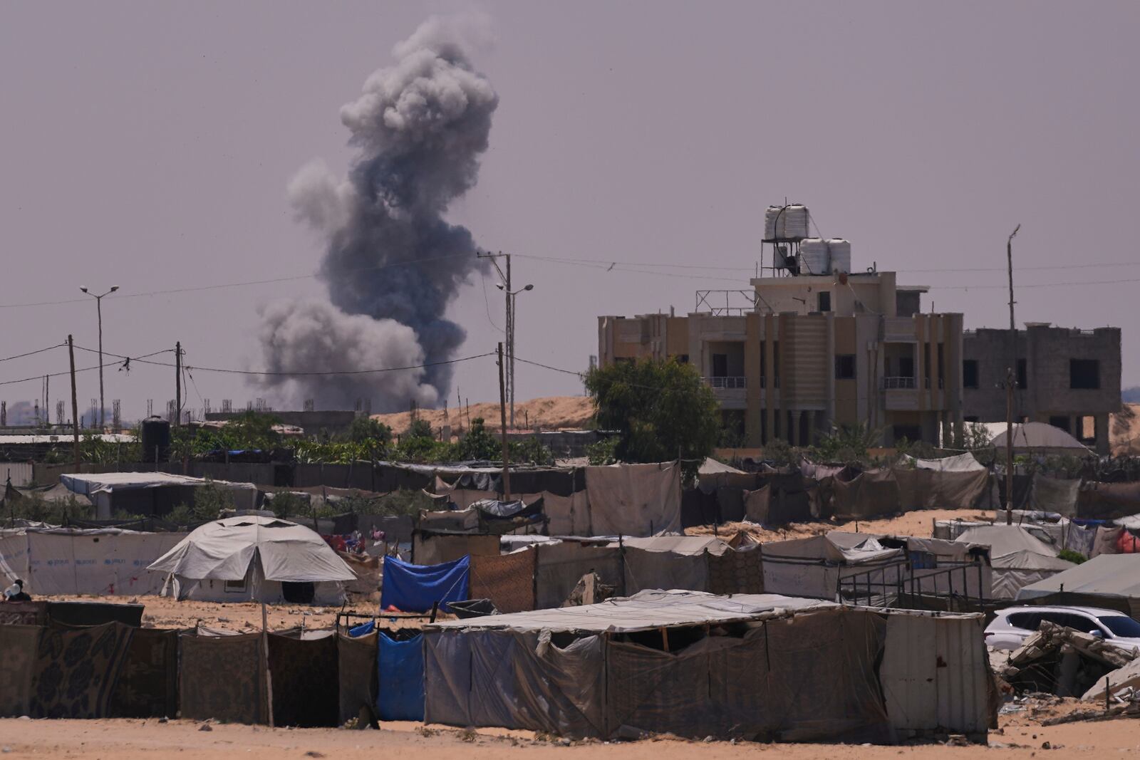 Smoke rises to the sky following an Israeli army airstrike in Khan Younis, southern Gaza Strip, Saturday, July 19, 2025. (AP Photo/Abdel Kareem Hana)
