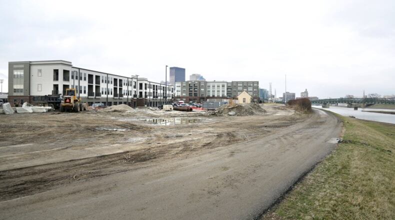 Plans for the next phase of the Water Street District in downtown Dayton call for adding 54 new housing units along and near the Mad River. LISA POWELL / STAFF