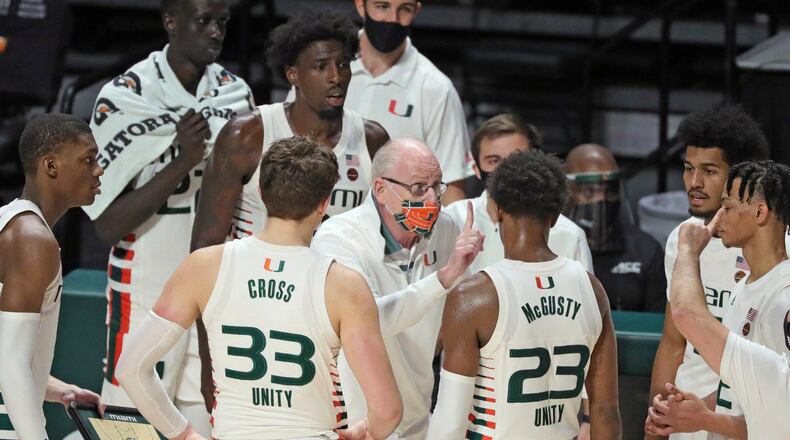 Miami coach Jim Larranaga talks to players during the second half of the team's NCAA college basketball game against Purdue on Tuesday, Dec. 8, 2020, in Coral Gables, Fla. (Al Diaz/Miami Herald via AP)
