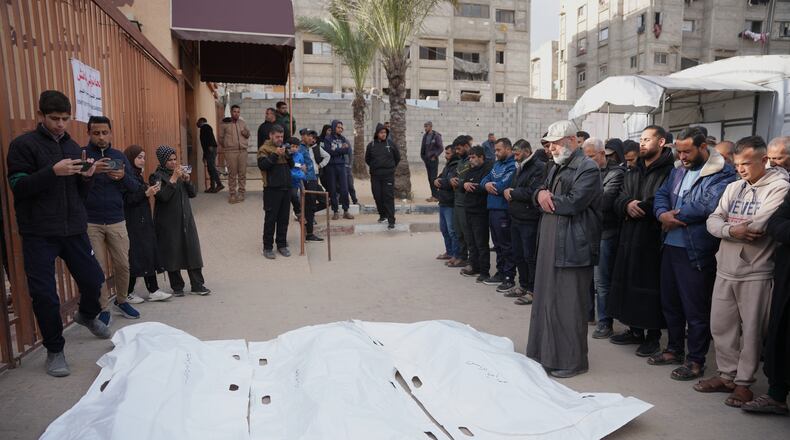 Palestinians mourn over the bodies of men who were killed in an Israeli military strike, during their funeral at Nasser Hospital in Khan Younis, Wednesday, Feb. 4, 2026. (AP Photo/Abdel Kareem Hana)