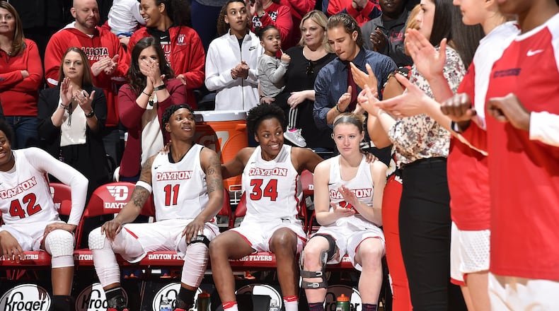 Dayton’s three seniors — Alex Harris (11), Javonna Layfield (34) and Jenna Burdette (14) — before Sunday’s Senior Day game vs. Fordham at UD Arena. Erik Schelkun/CONTRIBUTED