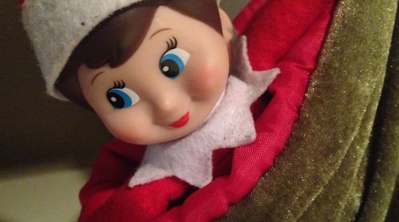 Hiding in plain sight helps an Elf on the Shelf do her job. Here she is, waiting patiently to be discovered by a child who isn’t bothering to look for her. NEDRA RHONE / NRHONE@AJC.COM