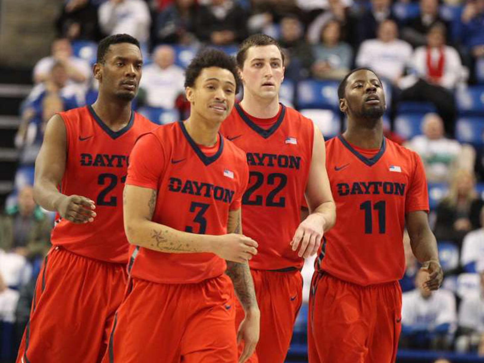 Dayton players (left to right) Dyshawn Pierre, Kyle Davis, Bobby Wehrli and Scoochie Smith head to a huddle in the final seconds of a victory against Saint Louis on Tuesday, Feb. 23, 2016, at Chaifetz Arena in St. Louis, Mo. David Jablonski/Staff