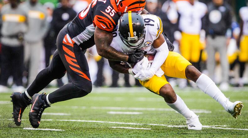 Cincinnati Bengals linebacker Vontaze Burfict tackles Pittsburgh Steelers wide receiver JuJu Smith-Schuster during their game Sunday, Oct. 14, 2018, at Paul Brown Stadium in Cincinnati. The Steelers won 28-21. NICK GRAHAM/STAFF