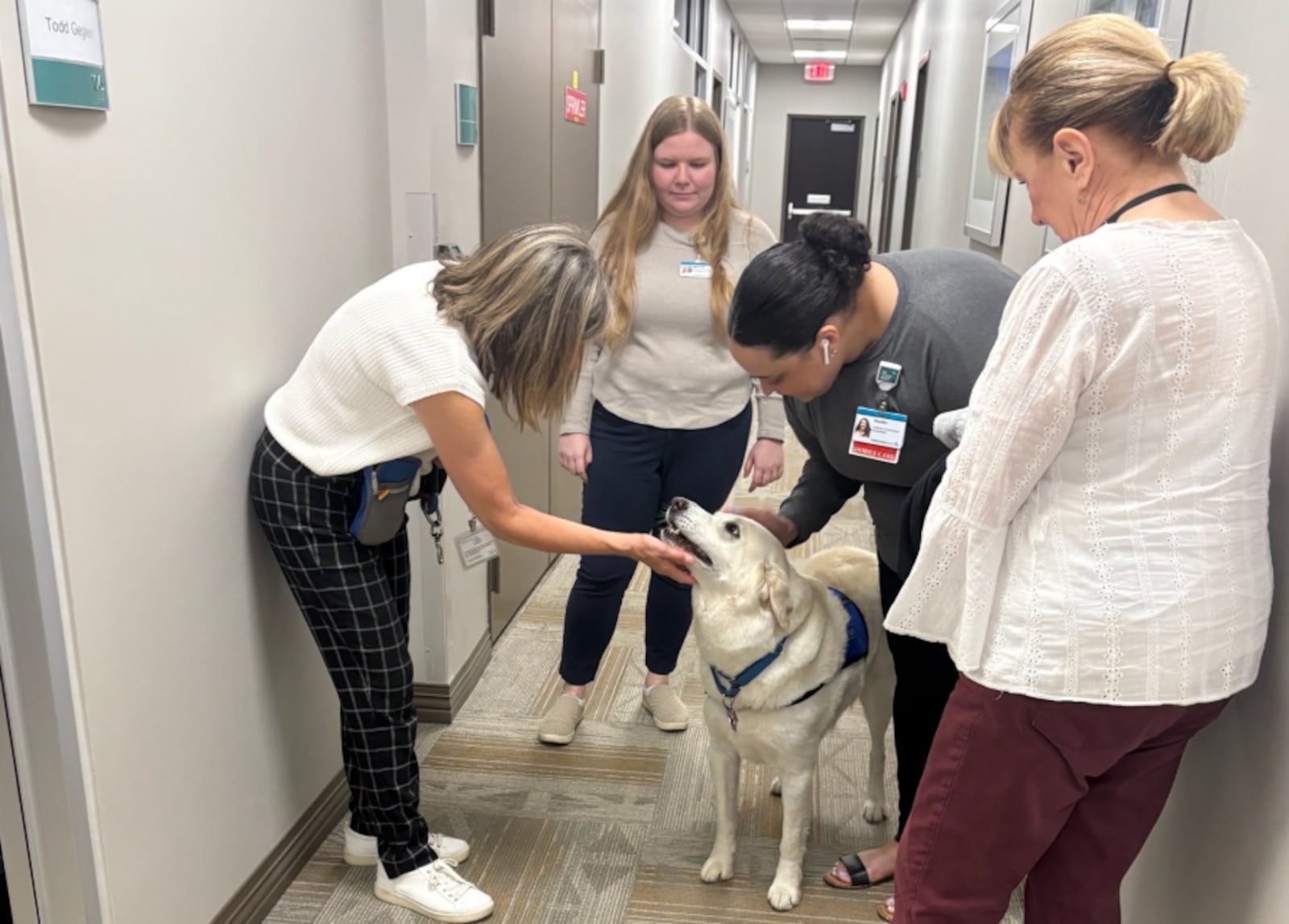 Miami Valley Pet Therapy Association volunteer Cindi Heck and her dog Nick visit with Kettering Transportation Services Hospital Transport Coordinators (left to right) Miranda Tatom, Hunter Mims and Barb Trump. CONTRIBUTED