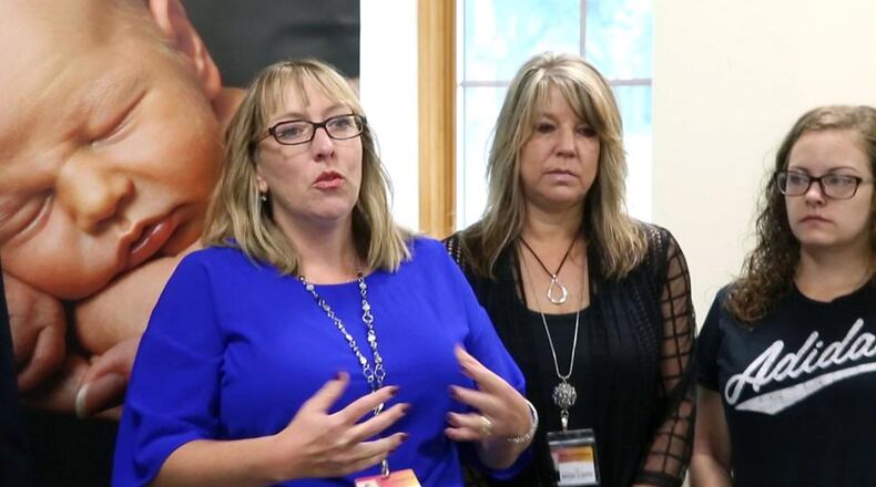 Jill Kingston, left, executive director of Brigid’s Path, is shown in a file photo talking about family-based treatment options for babies suffering from neonatal abstinence syndrome (NAS). With Kingston are Kim Kleinhans, director of Family Advocacy, center, and Ashley Evans, a client of Brigid’s Path. TY GREENLEES / STAFF