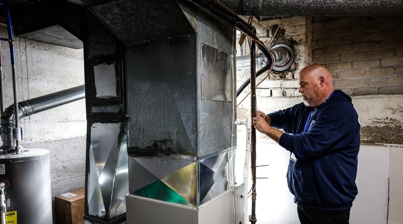 Gene Bourne, a utility quality control inspector for Miami Valley Community Action Partnership, shows off a furnace Friday, Oct. 28, 2022, at the partnership's new training center. He demonstrated what should be checked and done to the furnace to ensure optimal performance. JIM NOELKER/STAFF