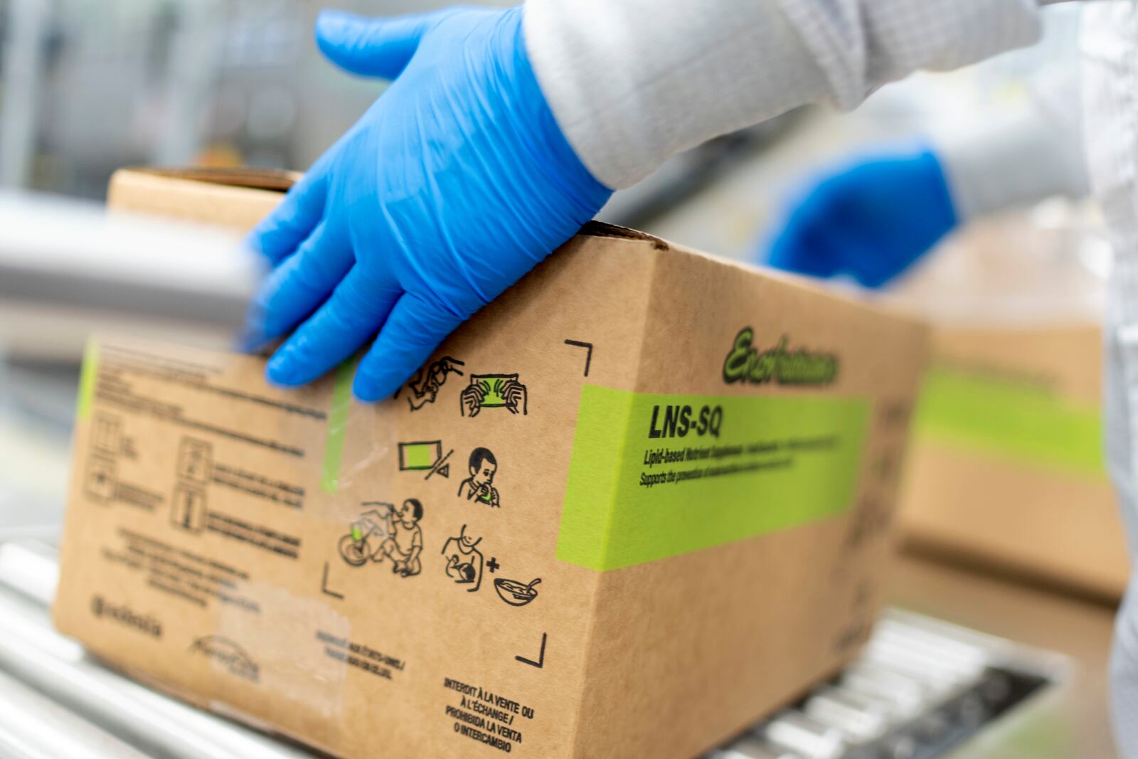 A worker seals a box of Plumpy'Nut, a nutritional lifesaving peanut paste sent to malnourished children worldwide, at Edesia Nutrition, Friday, March 14, 2025, in North Kingstown, R.I. (AP Photo/David Goldman)