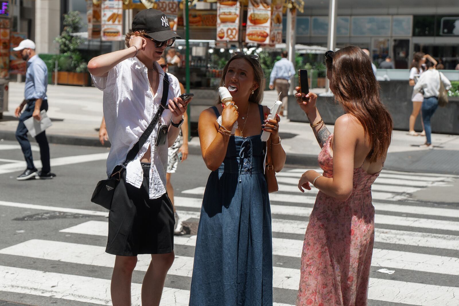 Woman takes a bite of an ice cream cone during a heatwave on Tuesday, June 24, 2025, in New York. (AP Photo/Olga Fedorova)