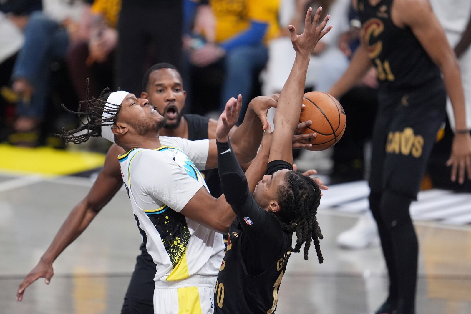 Indiana Pacers center Myles Turner, left, collides with Cleveland Cavaliers guard Darius Garland, right, during the first half of Game 3 in the Eastern Conference semifinals of the NBA basketball playoffs in Indianapolis, Friday, May 9, 2025. (AP Photo/Michael Conroy)