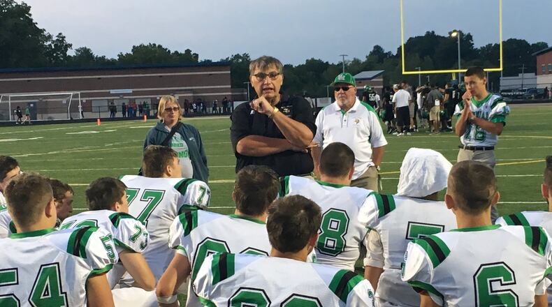 New Miami coach John Singleton talks to his team after the Vikings dropped a 20-6 decision to Gamble Montessori on Aug. 26 at Woodward. RICK CASSANO/STAFF