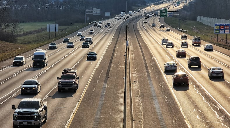 Vehicles drive on Interstate 75 in Warren County on Friday, Dec. 18, 2020. Experts expect about a third fewer Ohioans to travel this holiday season. NICK GRAHAM / STAFF