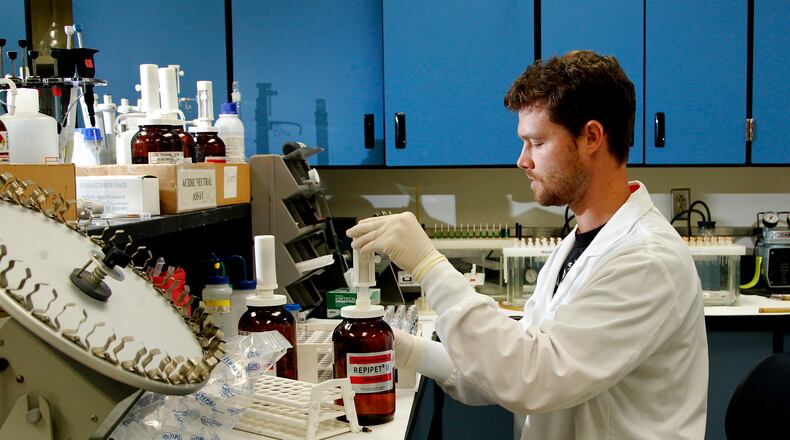 Quinton Carter, a forensic toxicologist at the Miami Valley Regional Crime Lab, prepares to run drug screenings. LISA POWELL / STAFF