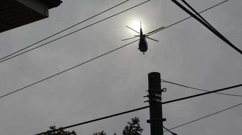 A medical helicopter flies near downtown Dayton. CORNELIUS FROLIK / STAFF