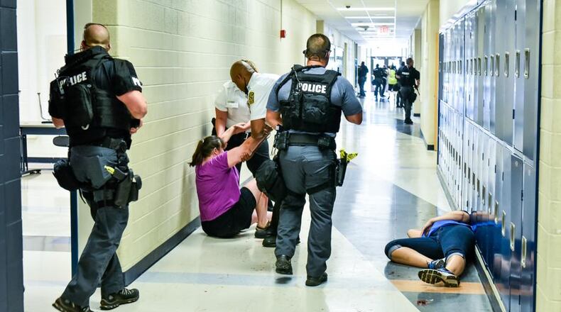 Some school districts - like Hamilton in this photo - have conducted mock, active-shooter attack drills on campus in preparation for upgrading security this school year. NICK GRAHAM/STAFF