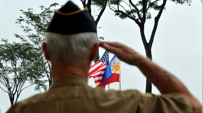 A retired American soldier salutes to the colors during Veterans Day JAY DIRECTO/AFP/Getty Images)