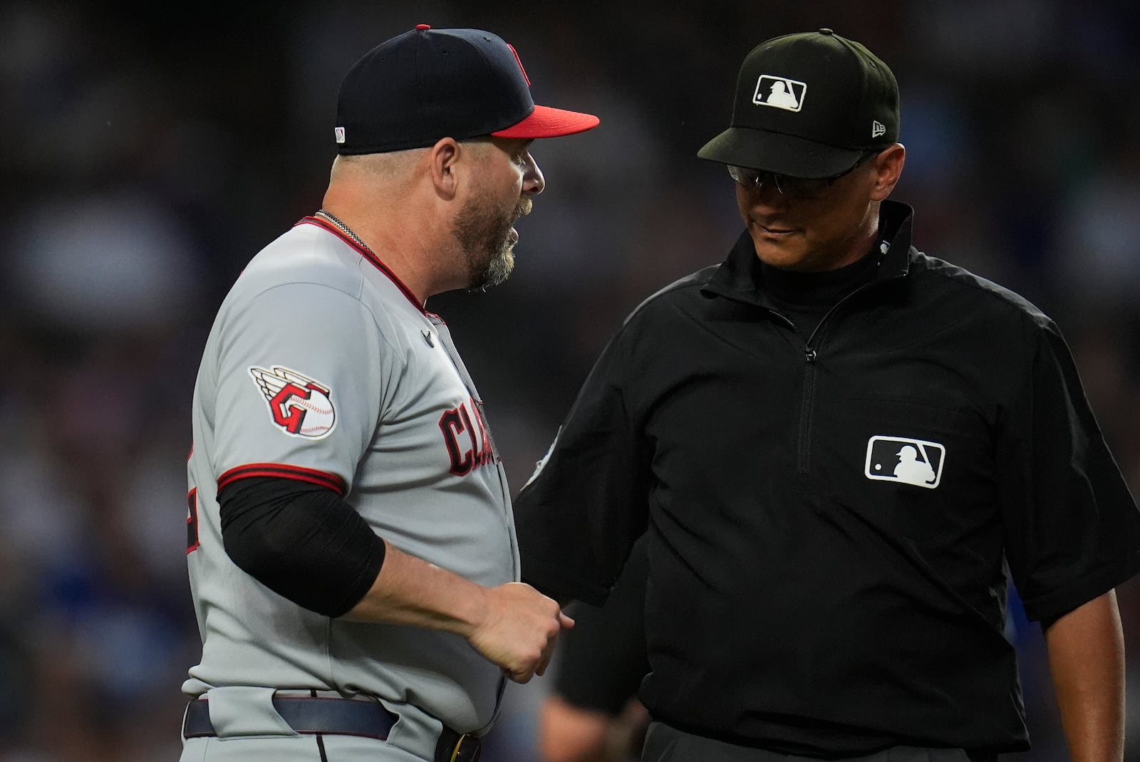 Cleveland Guardians manager Stephen Vogt (12), left, discusses a call with umpire Vic Carapazza (19) during the fourth inning of a baseball game against the Chicago Cubs, Wednesday, July 2, 2025, in Chicago. (AP Photo/Erin Hooley)