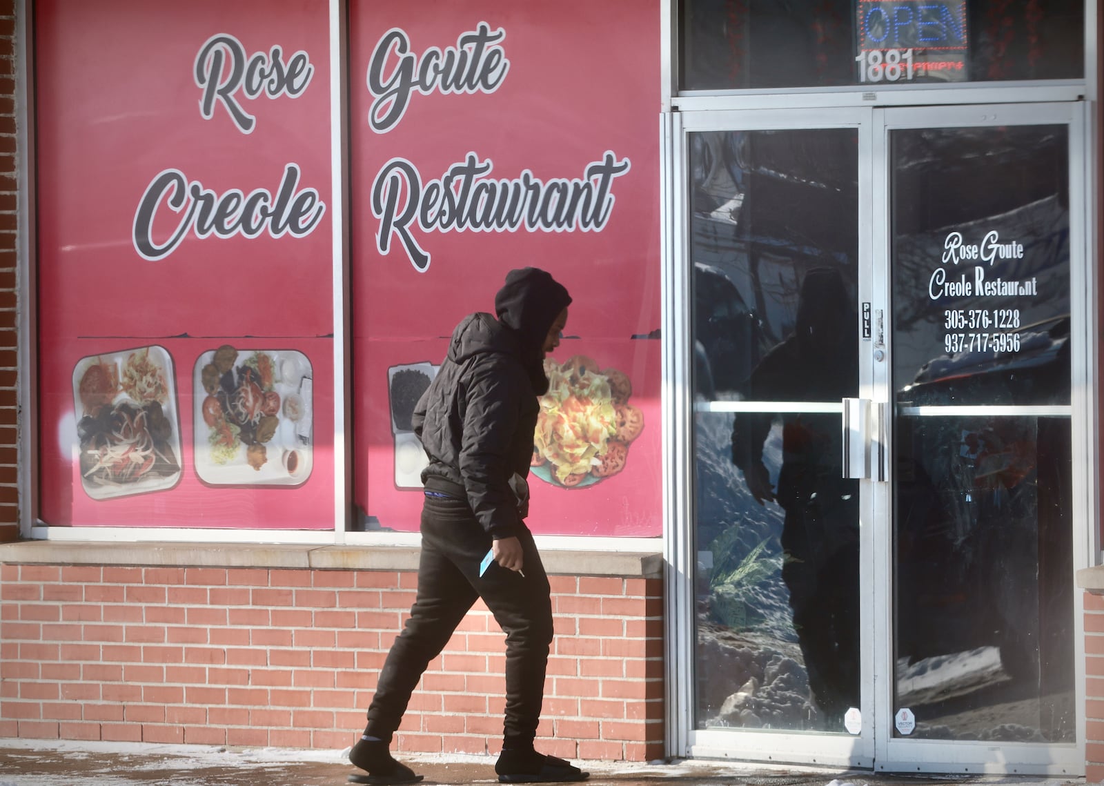 A man walks into the Haitian Rose Goute Creole Restaurant in Springfield Wednesday, Jan. 28, 2026. Contributed Photo Buck Creek Photography