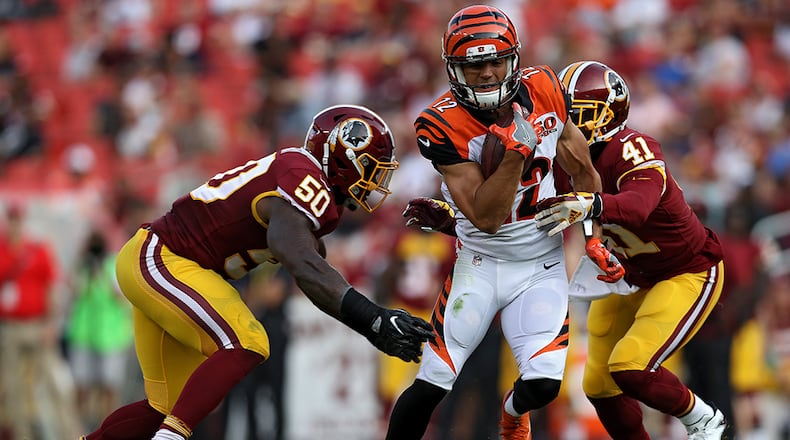 LANDOVER, MD - AUGUST 27: Wide receiver Alex Erickson #12 of the Cincinnati Bengals eludes Washington Redskins defenders in the second half during a preseason game at FedExField on August 27, 2017 in Landover, Maryland. (Photo by Patrick Smith/Getty Images)