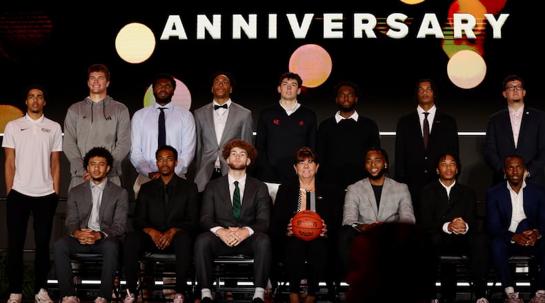 Men's basketball players, including Dayton's Javon Bennett (front row, left) pose for a photo at Atlantic 10 Conference Media Day on Tuesday, Sept. 30, 2025, in Pittsburgh. David Jablonski/Staff