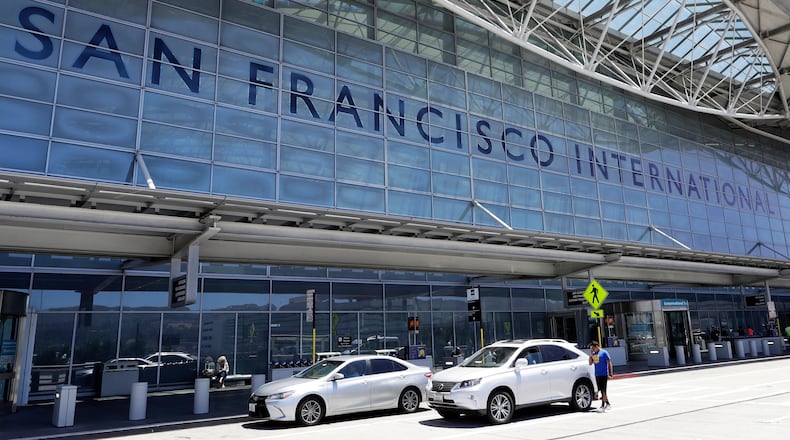 FILE - Vehicles wait outside the international terminal at San Francisco International Airport in San Francisco, July 11, 2017. (AP Photo/Marcio Jose Sanchez, File)