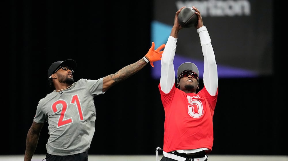 AFC wide receiver Tee Higgins, of the Cincinnati Bengals, right, catches a pass next to cornerback Denzel Ward, of the Cleveland Browns, during NFL Pro Bowl Games practice in San Francisco, Sunday, Feb. 1, 2026. (AP Photo/Godofredo A. Vásquez)
