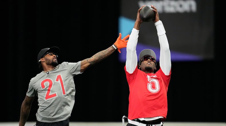 AFC wide receiver Tee Higgins, of the Cincinnati Bengals, right, catches a pass next to cornerback Denzel Ward, of the Cleveland Browns, during NFL Pro Bowl Games practice in San Francisco, Sunday, Feb. 1, 2026. (AP Photo/Godofredo A. Vásquez)