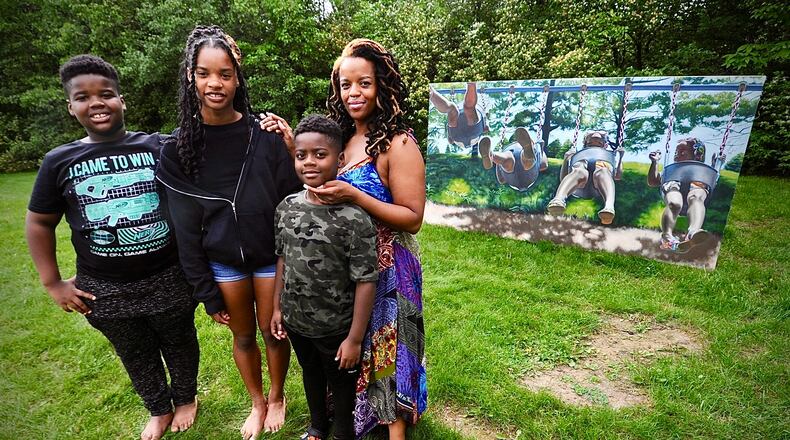 Mother and artist Erin Smith, right, with her family from left, Zachary Glenn,, age 10, Zion Glenn,, age 14, and Zavier Glenn, age 8,. MARSHALL GORBY\STAFF
