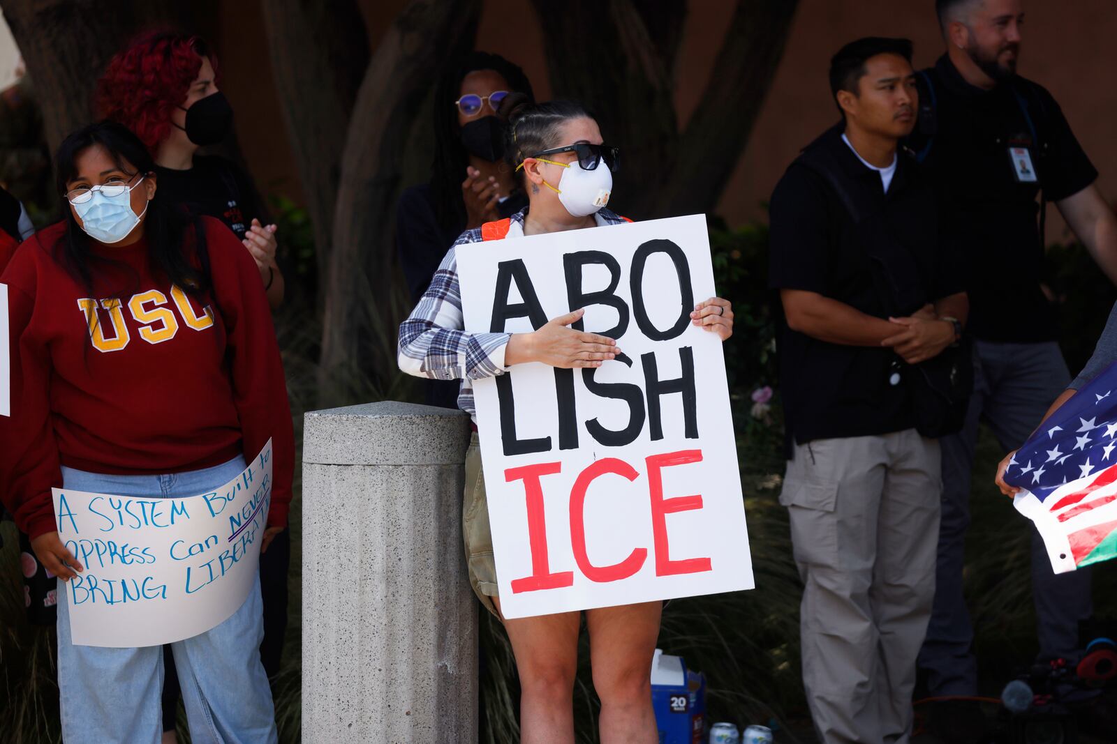 Demonstrators hold signs as they protest, Thursday, June 12, 2025, in Los Angeles. (AP Photo/Etienne Laurent)
