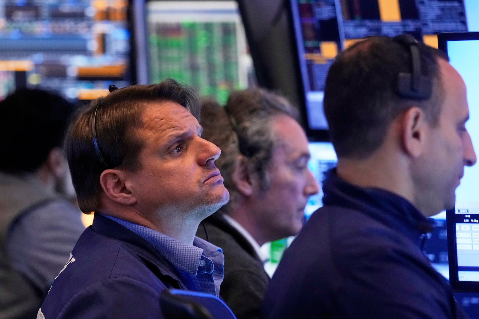 Trader Michael Milano, left, works with colleagues on the floor of the New York Stock Exchange, Tuesday, May 27, 2025. (AP Photo/Richard Drew)