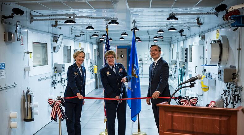 Maj. Gen. Heather Pringle, Air Force Research Laboratory commander; Lt. Gen. Dorothy Hogg, Air Force surgeon general; and Darrell Phillipson, 711th Human Performance Wing acting director; cut the ceremonial ribbon during the opening of the new research altitude chambers May 27 at Wright-Patterson Air Force Base. The four computer-controlled altitude chambers will perform a variety of studies to ensure the durability of flight equipment as well as to determine the effects altitude has on the human body. U.S. AIR FORCE PHOTO/RICHARD ELDRIDGE