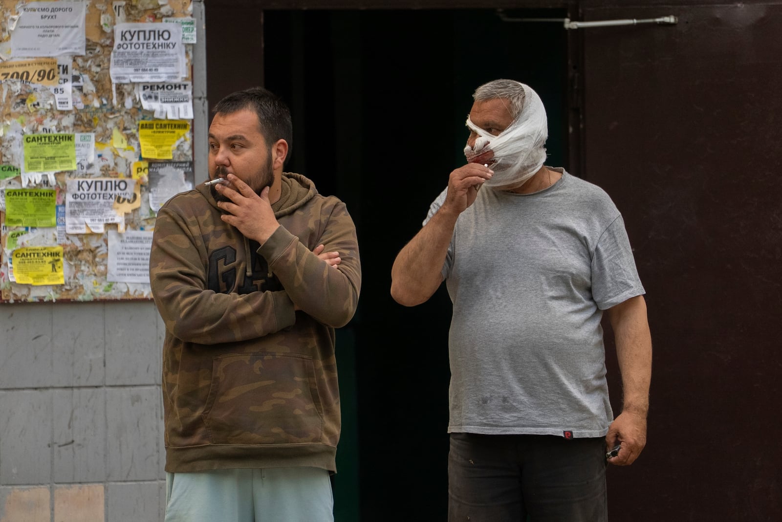 Injured victims stand and smoke after a Russian airstrike in a residential neighborhood in Kyiv, Ukraine, Thursday, April 24, 2025. (AP Photo/Alex Babenko)