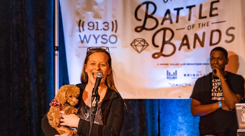 Libby Ballengee holds Misty on stage at The Brightside during Dayton Battle of the Bands. CONTRIBUTED PHOTOS