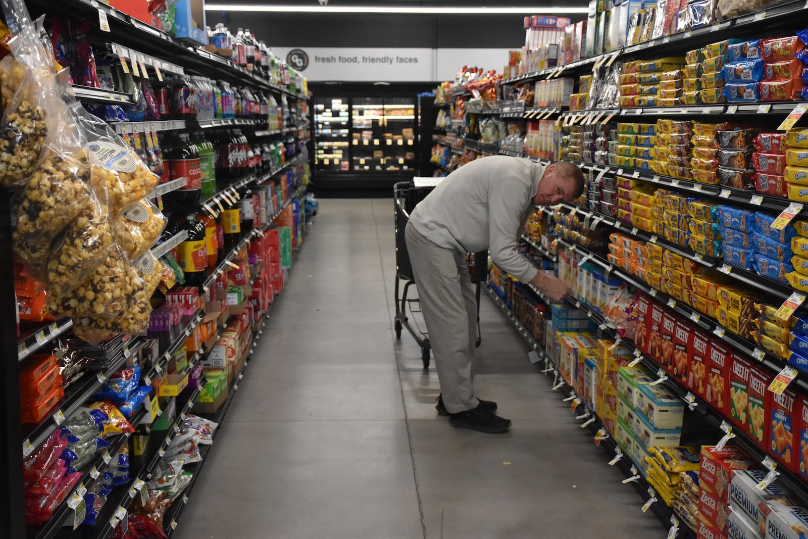 Mark Riccardi, a member of Acosta's sales and marketing team, arranges and organizes grocery items at the Gettysburg Grocery (GG's) in southwest Dayton. CORNELIUS FROLIK/ STAFF