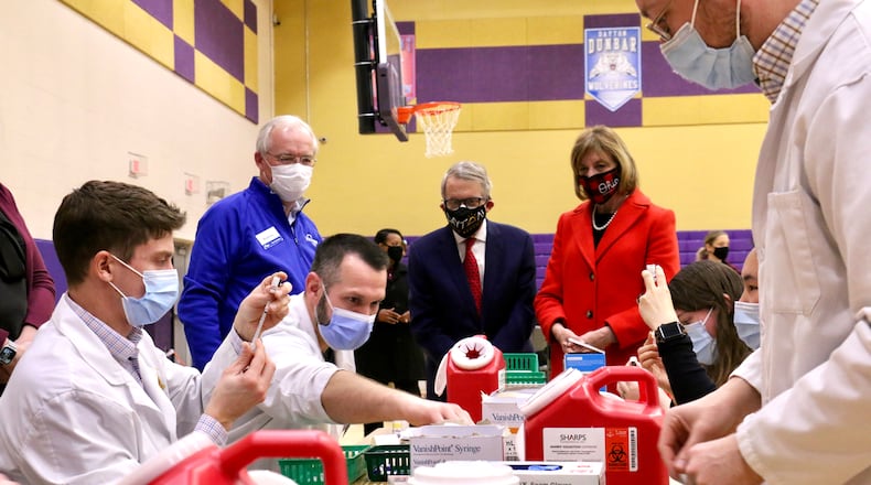 Gov. Mike DeWine and his wife, Fran, visit a COVID-19 vaccination clinic at Thurgood Marshall High School in Dayton on Sunday/ CONTRIBUTED