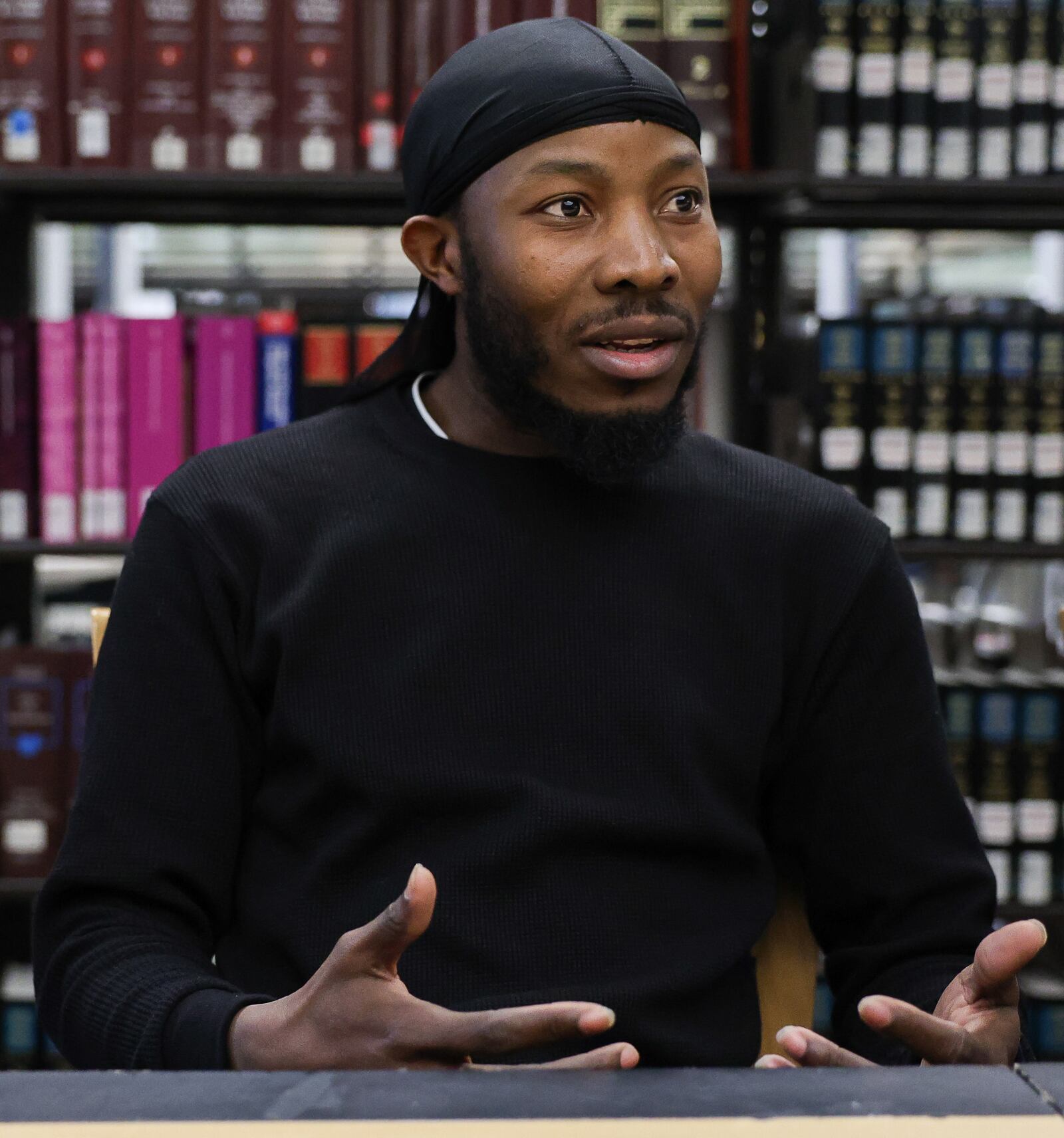 Roudechel Charpentier talks during an interview on March 28 at Sinclair Community College. His temporary protective status application remains pending with no word on when, or if, it will be resolved. BRYANT BILLING / STAFF
